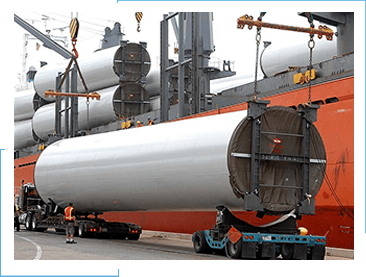 A large cylindrical industrial component being transported on a heavy-duty trailer.